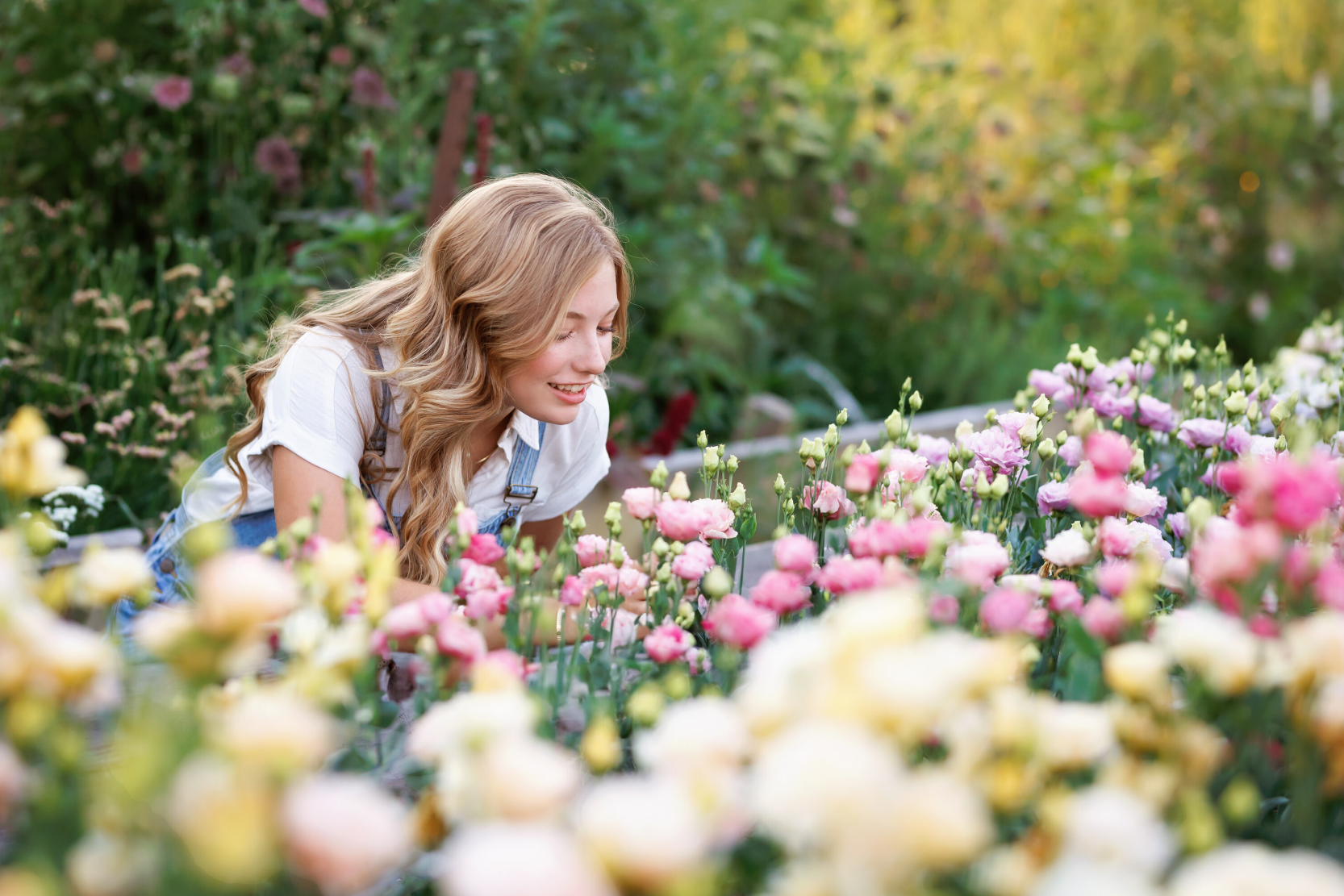 Lead florist carefully arranging hand-tied bridal bouquet with garden roses in the studio